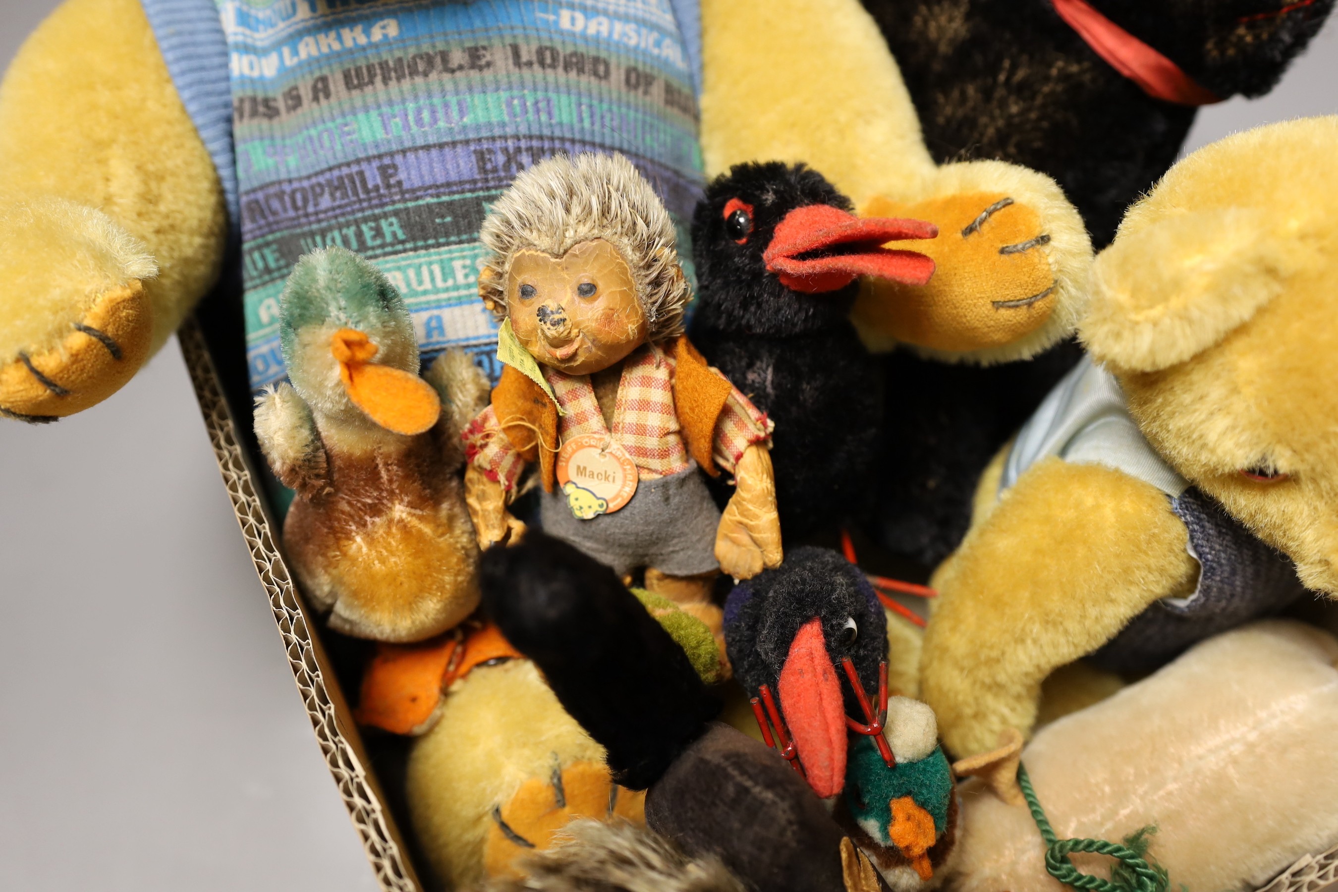 A collection of Steiff toys - a small black cat, a large black cat, a small pig, a hedgehog, a Macki hedgehog, two crows, a duck, two small birds with wire feet and two Peter Bull bears with pedigree certs. (12)